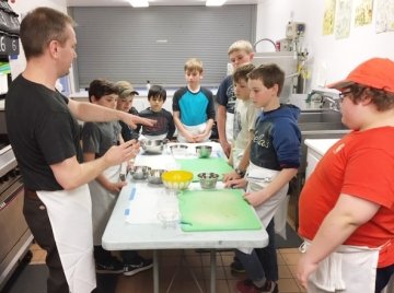 Group of young male teens in cooking class