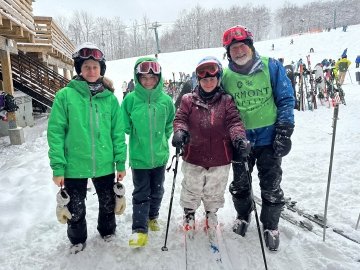 Group of Vermont Adaptive volunteers and participant