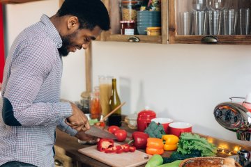 Male cutting up vegetables